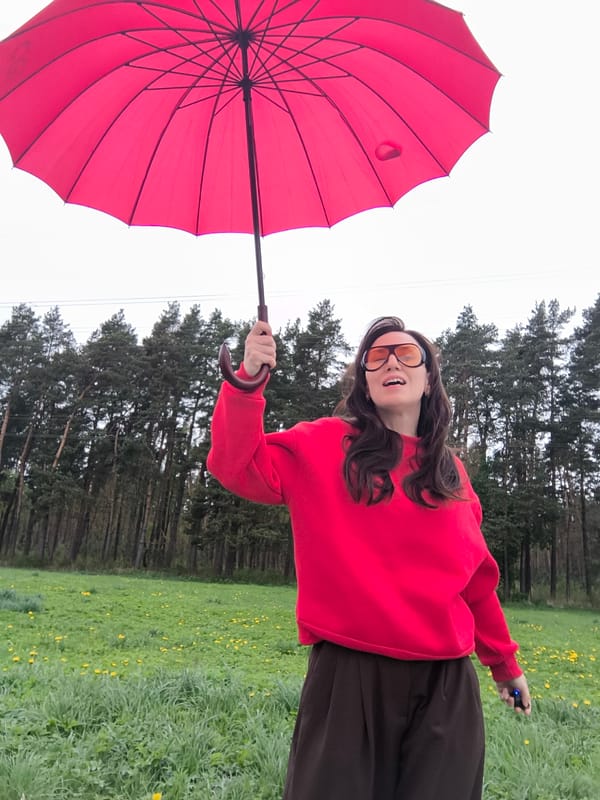 Woman with red umbrella spotted in Riga meadow, park