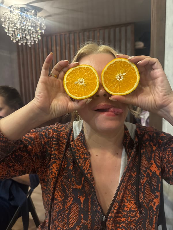 Oranges, gladiolus, and a goofy pose in Sochi