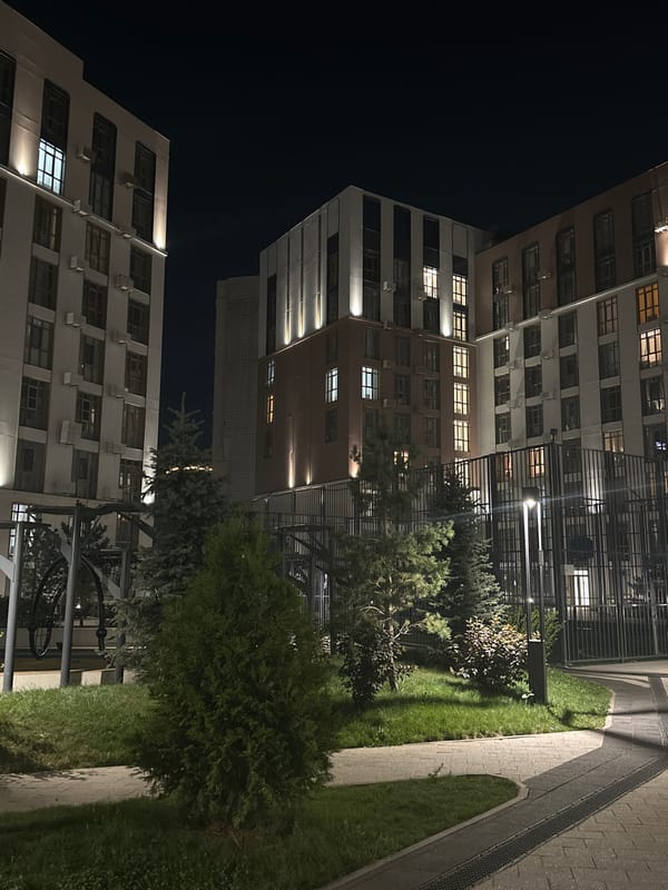 Nighttime walkthrough of a modern apartment complex and its gardens