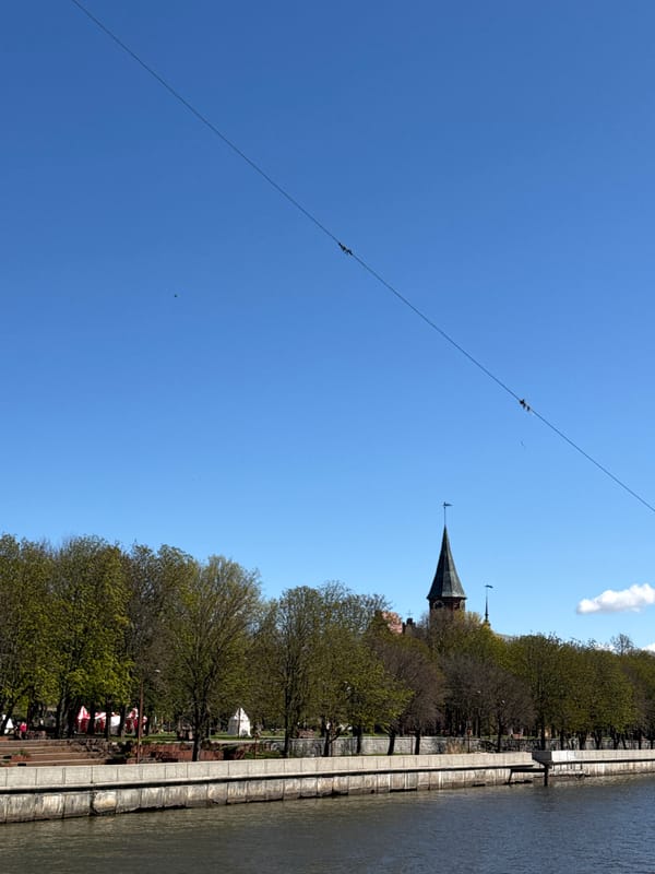 Tourist documents sunny morning walk through historic Kaliningrad waterfront