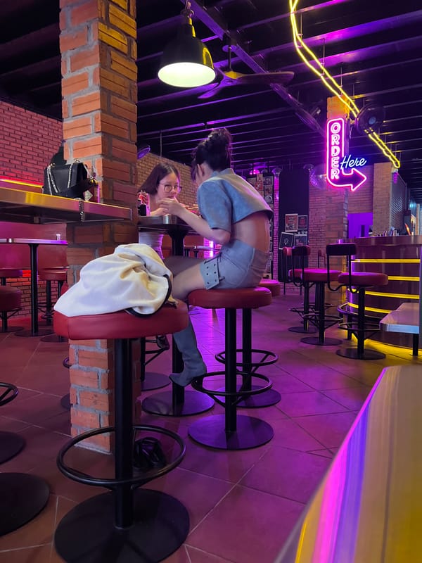 Casual dining and arcade gaming captured at Vietnam burger restaurant