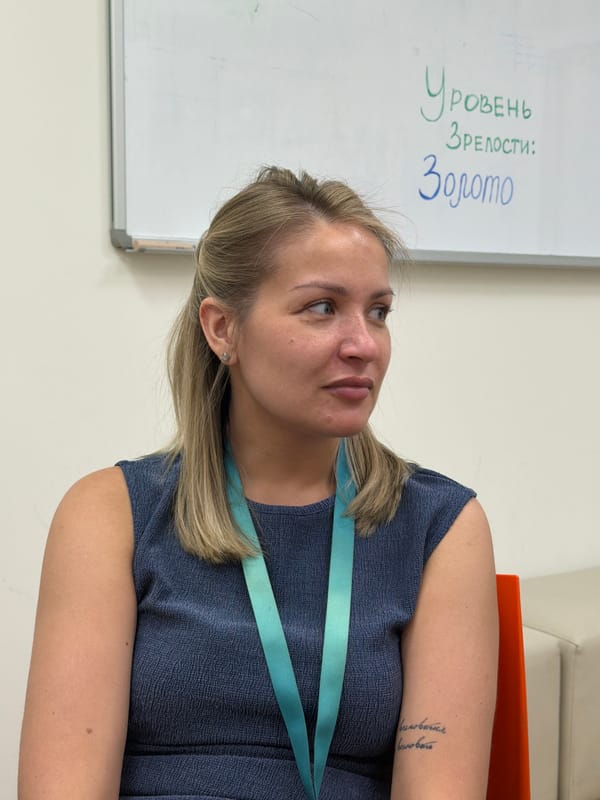 Woman observed studying whiteboard in Krasnoyarsk classroom setting