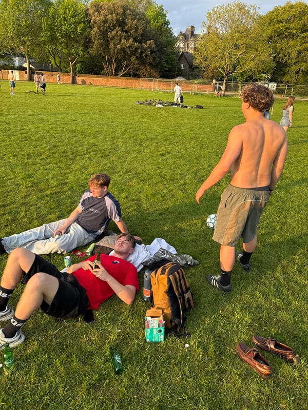 Young men enjoy sunny afternoon soccer gathering in Cardiff park