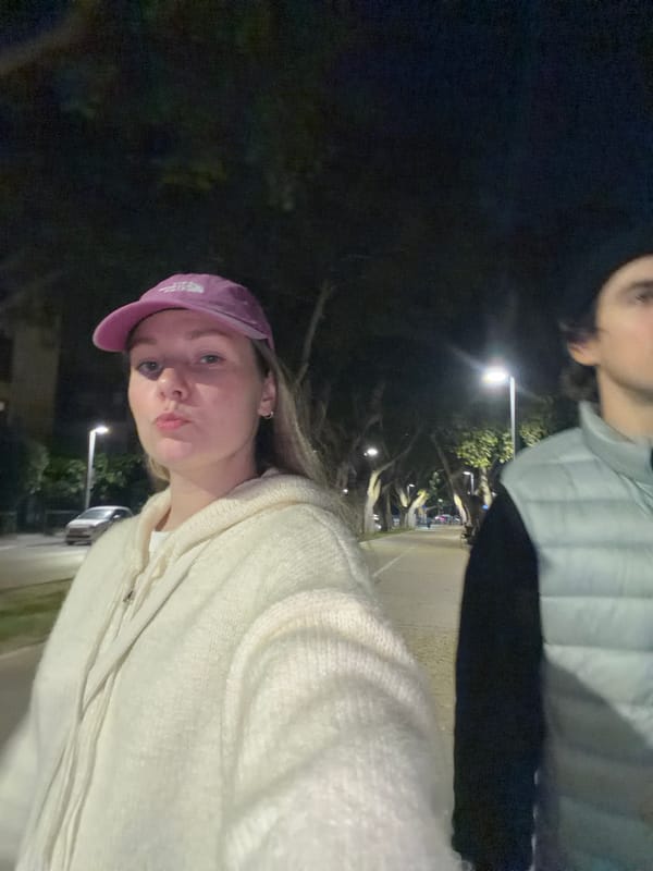 People gather around illuminated tree in Tel Aviv
