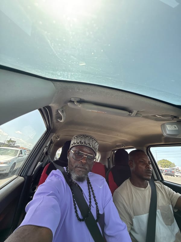 Two men travel by car in Ojomu, Nigeria