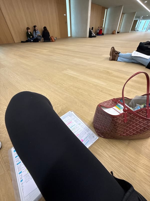 People gathered in Parisian building with papers and staircase