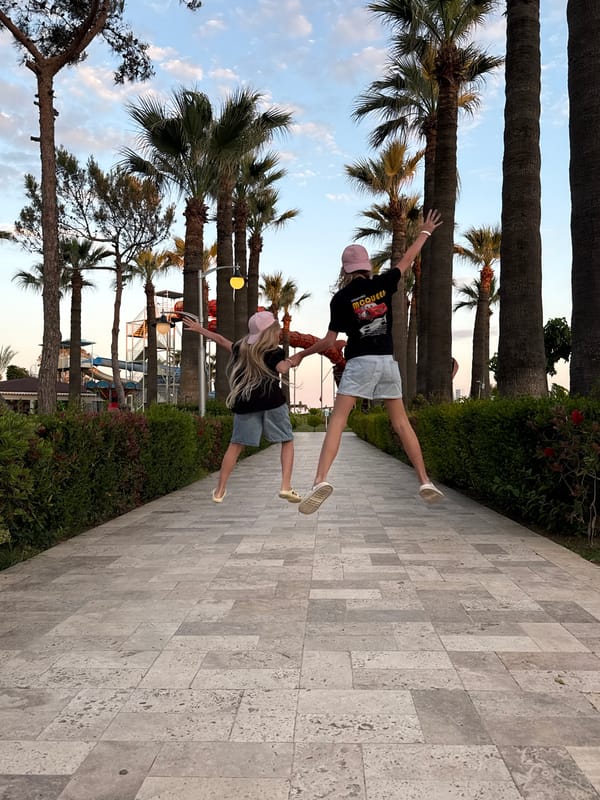Two youths pose in matching outfits near Serik water park