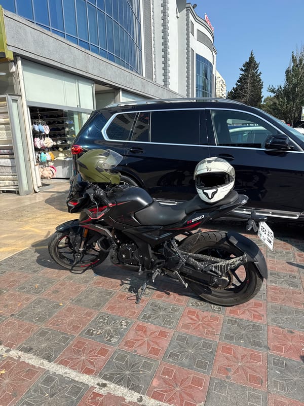 Street-level Baku: bikes, a vendor stall, and city signage