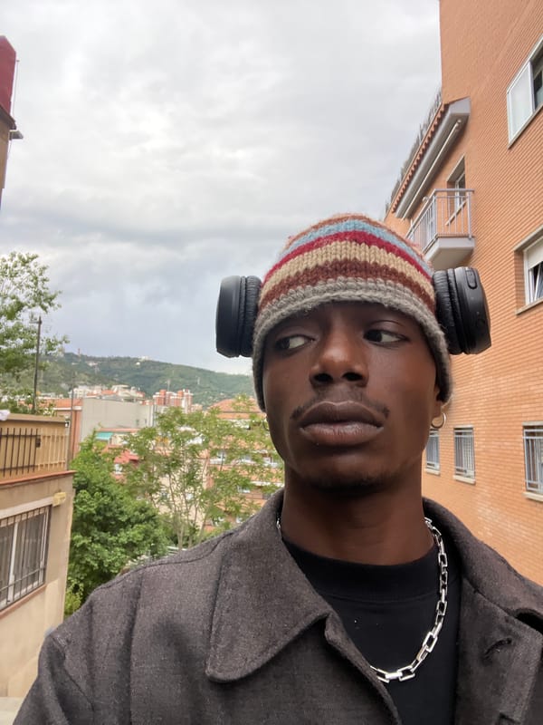 Man in striped beanie photographed multiple times on Barcelona street