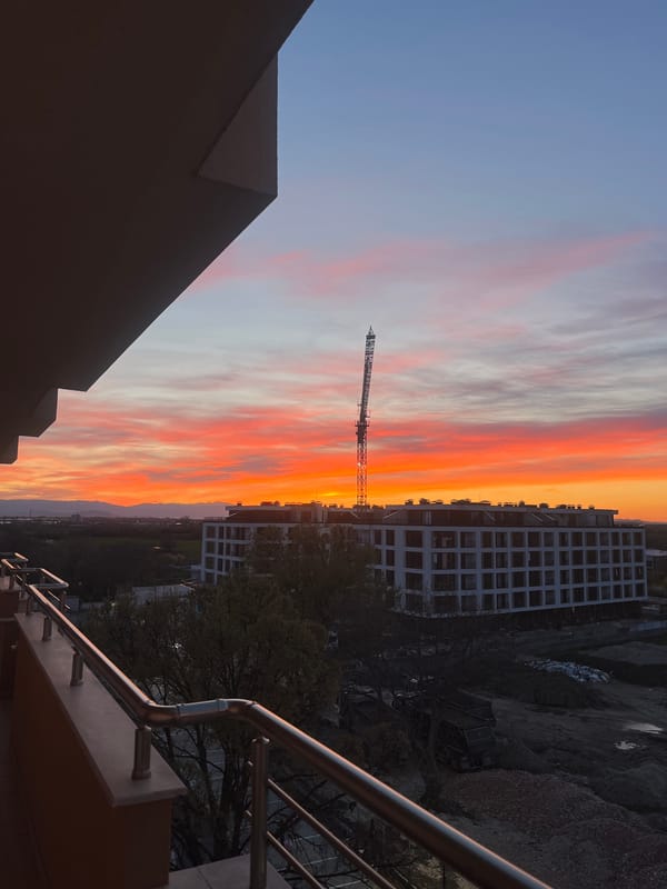 Construction crane silhouetted against colorful sunset in Plovdiv, Bulgaria