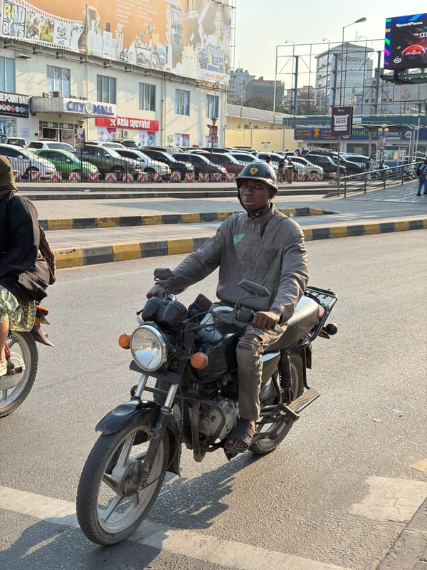 Midday street traffic and pedestrians moving through Dar es Salaam