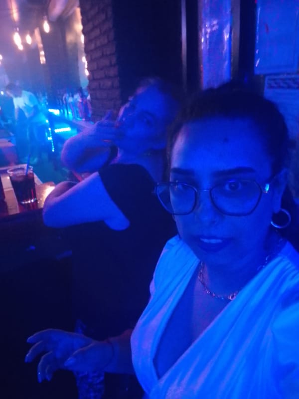 Late-night bar selfies in blue-lit club surroundings