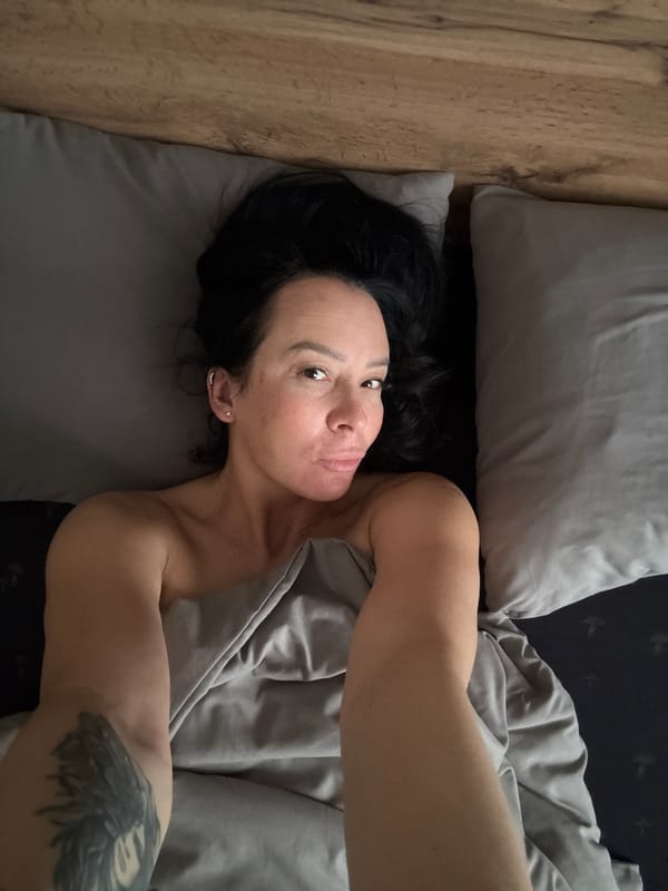 Woman and dog captured in quiet bedroom moments in Chaikovsky