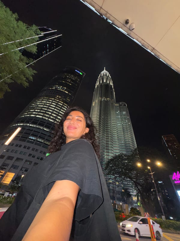 Woman documents nighttime visit to Petronas Towers in Kuala Lumpur