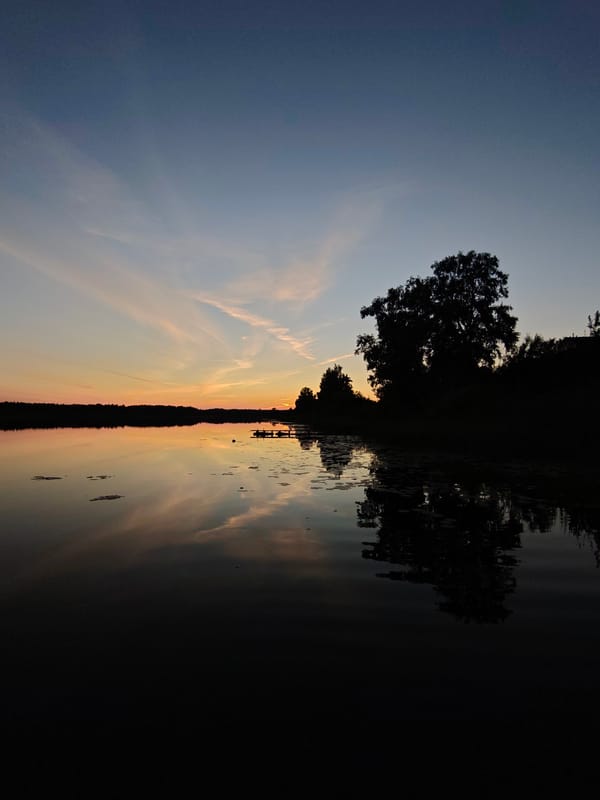 Sunset over a calm lake near Inogoshcha, Russia