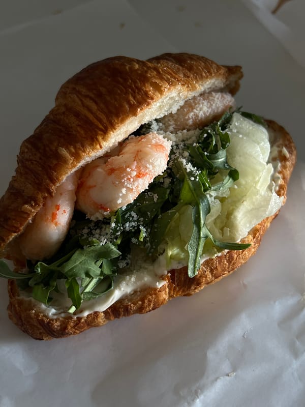 Shrimp and arugula croissant sandwich in Lviv