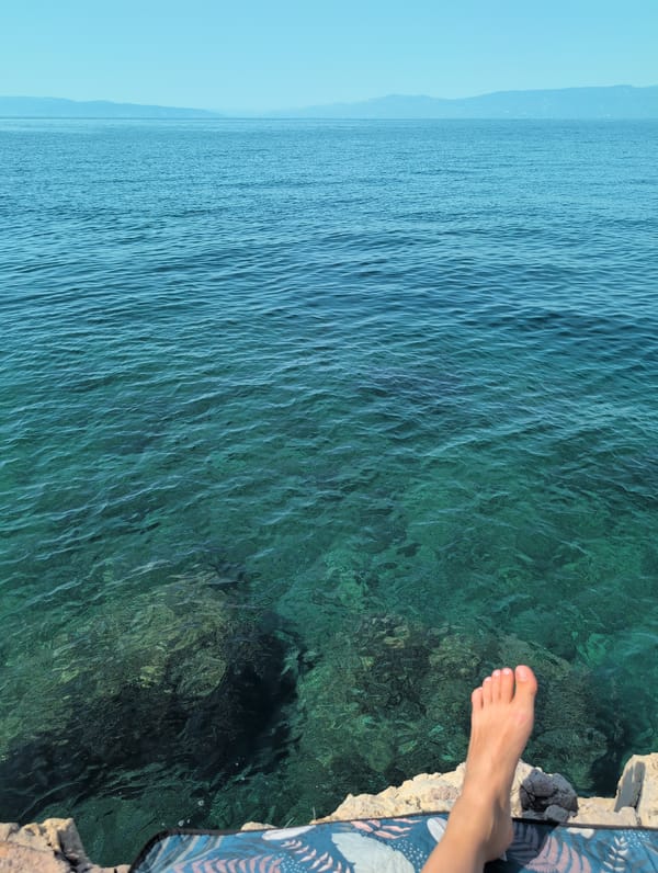 Lazy summer morning swimming and lounging on Kostrena's rocky Adriatic shore