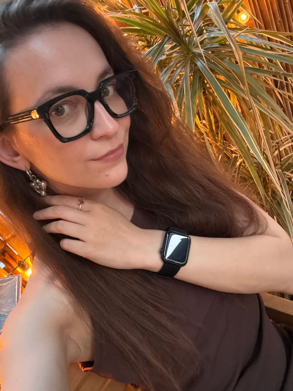 Woman takes selfies on Moscow street during afternoon