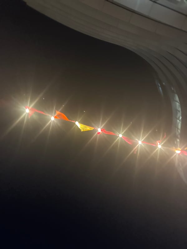 Modern London building illuminated with string lights after dark