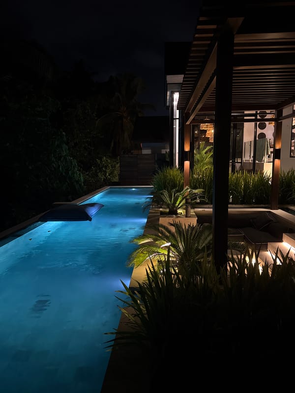 Illuminated infinity pool observed at night in Ubud District