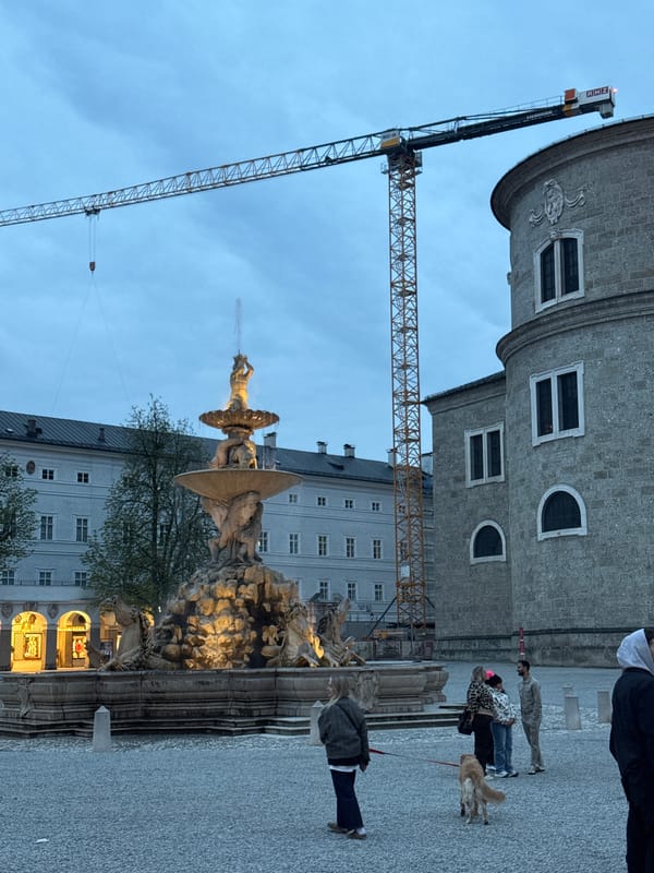 Evening street life documented across historic Salzburg landmarks
