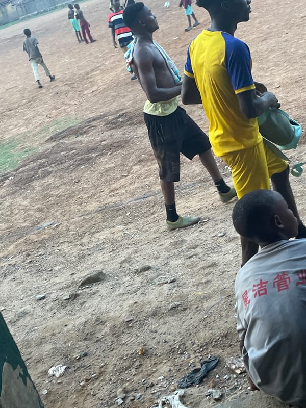 Youth gather on dirt sports field in Akwanga, Nigeria