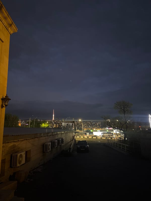 Yerevan TV Tower illuminated against twilight sky