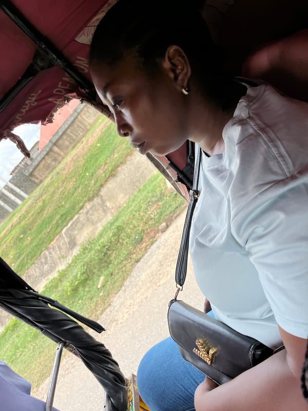 Passengers ride tricycle taxi through Abuja area Thursday morning