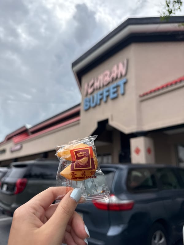 Diner enjoys fortune cookie and raw oyster at Kissimmee restaurant