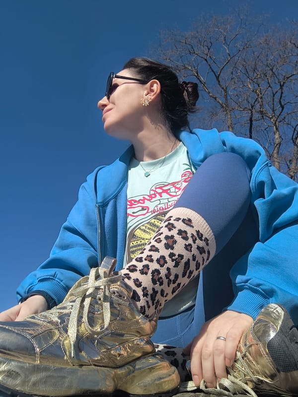 Woman sits in Riga park on clear morning