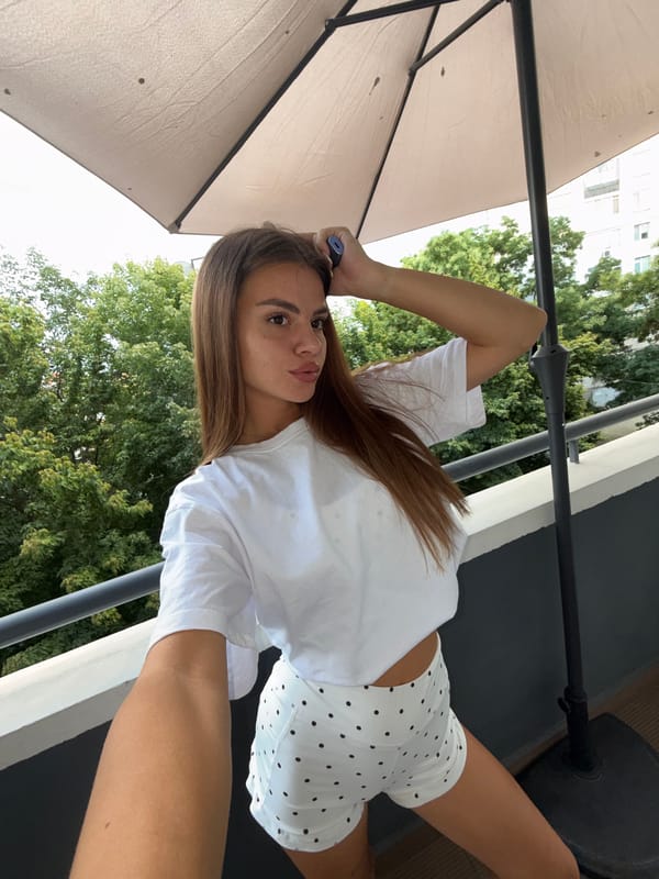 Balcony selfie session in Plovdiv with greenery behind