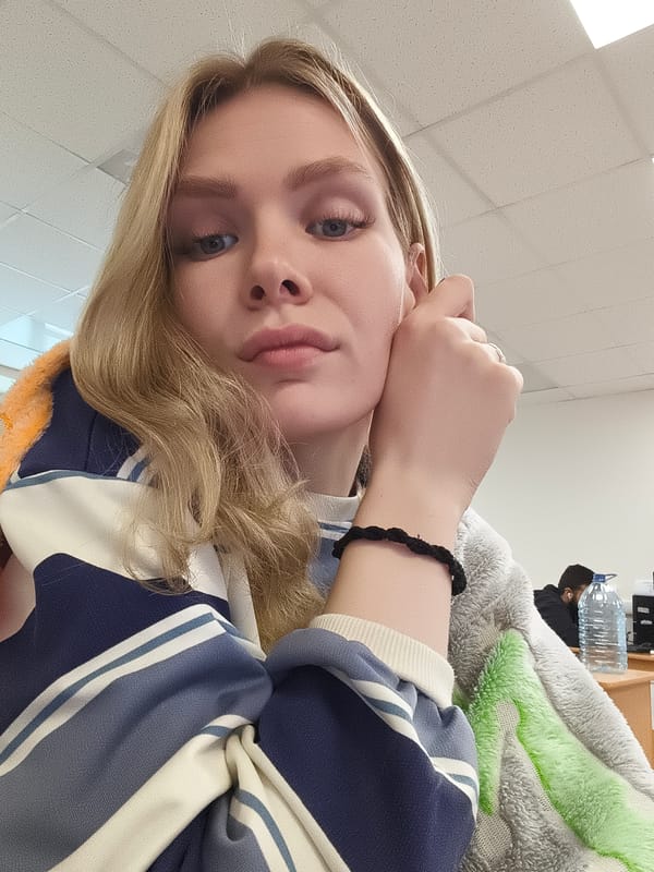 Woman touches ear in indoor setting, Izhevsk, Russia