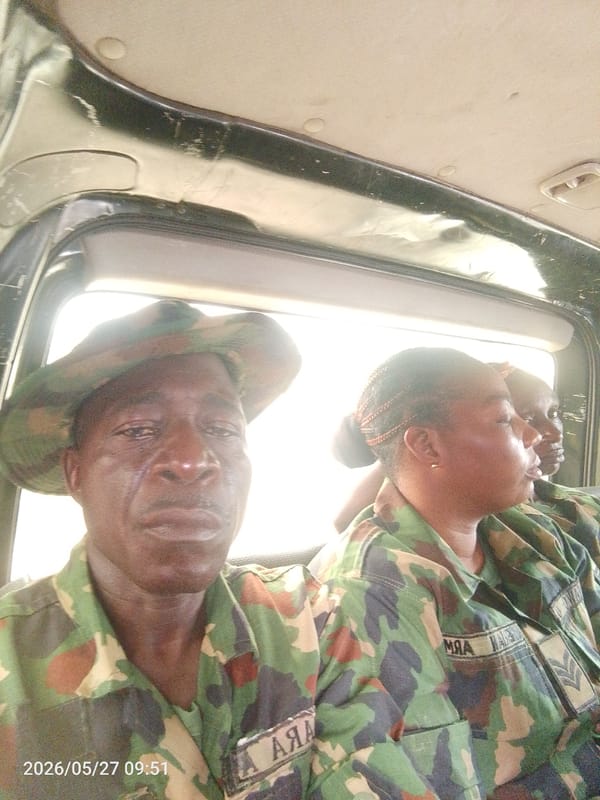 Military personnel transit through busy Lokoja streets amid civilian activity