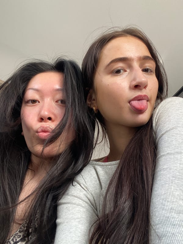 Two women pose for playful photo in London