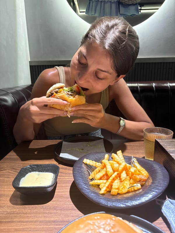 Woman enjoys burger and fries at Đà Nẵng restaurant