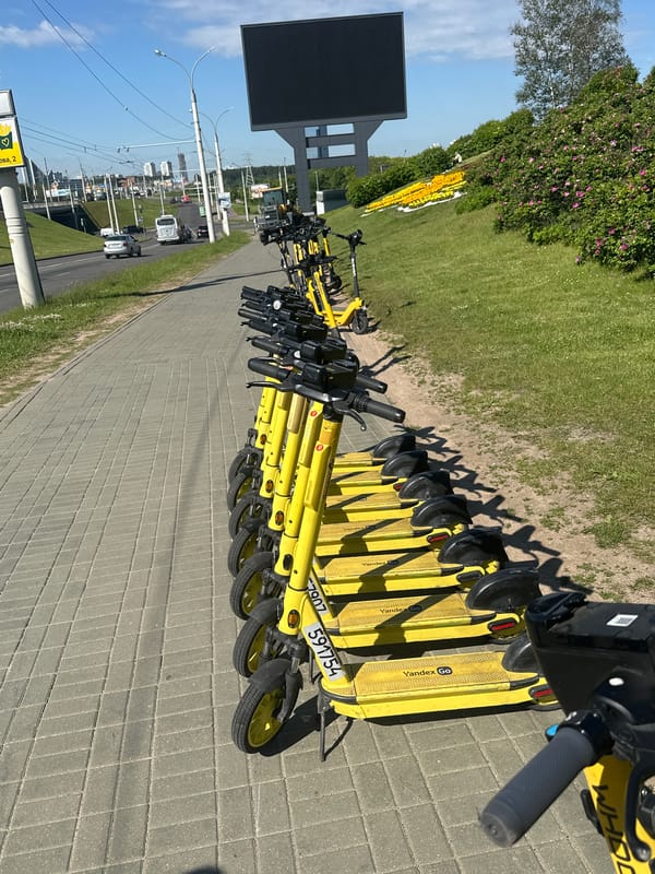 Morning scenes captured across Minsk: scooters, buildings, flower gardens