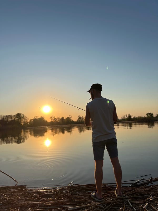 Angler fishes at sunset in Borovoye Matyushino, Russia