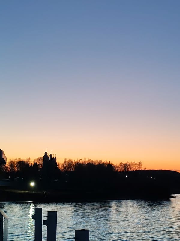 Twilight scene documented over water body with colorful sky