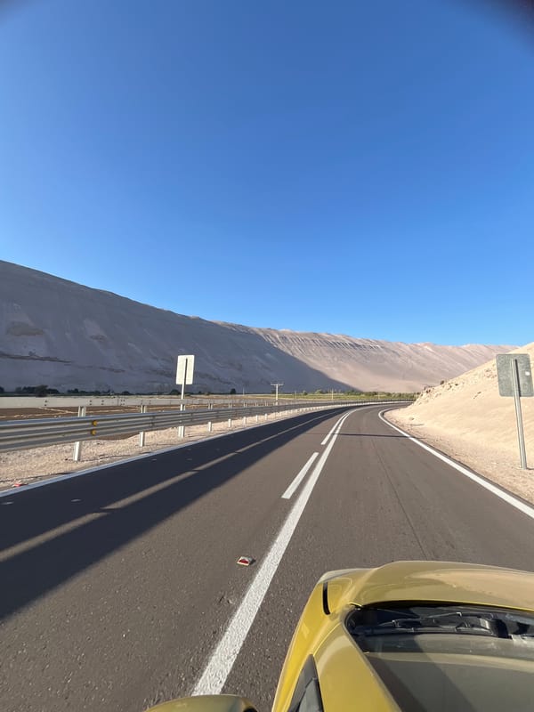 Driver travels highway in Arica, Chile under clear skies