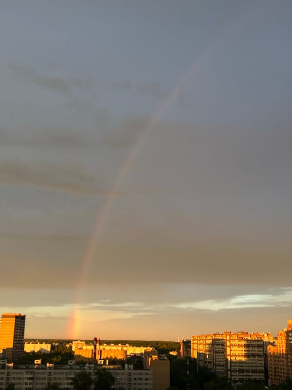 Rainbow over Dolgoprudny rooftops at golden hour