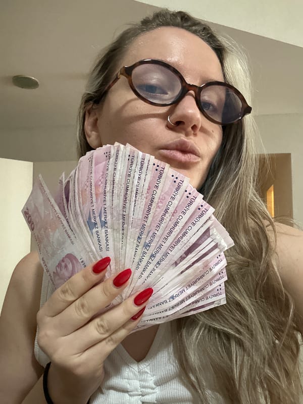 Woman displays Turkish Lira banknotes alongside personal collections in Esenyurt