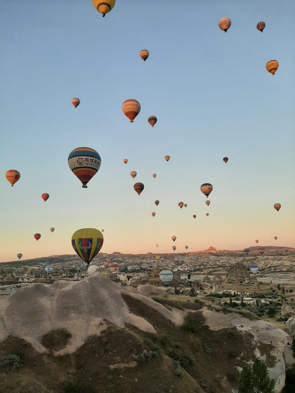 Hot air balloons fill the sky over Avanos at sunrise