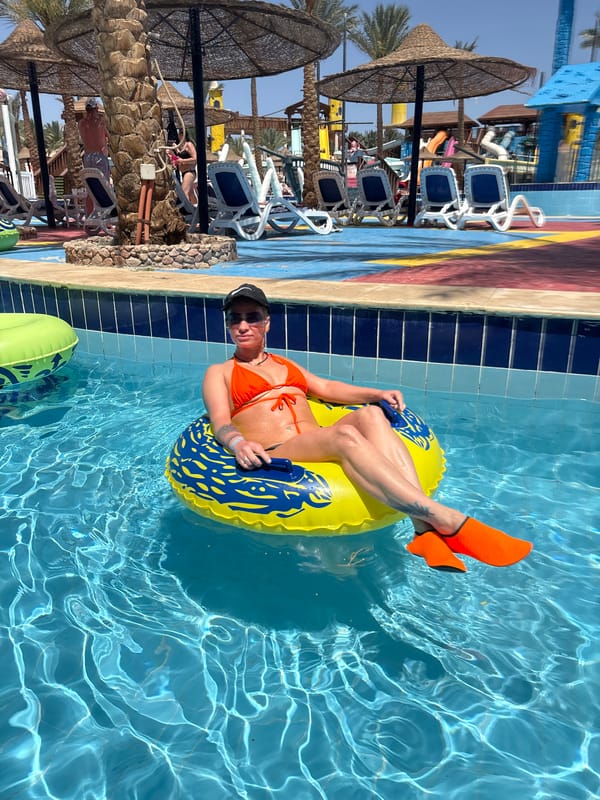 Tourist poses with replica pharaoh statue in Egyptian city