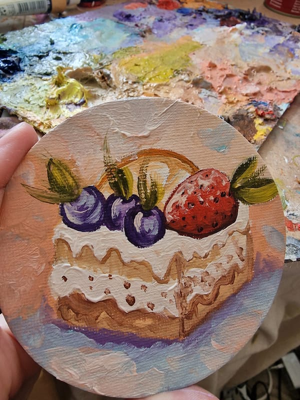 Artist creates small paintings in historic Veliko Tarnovo workspace