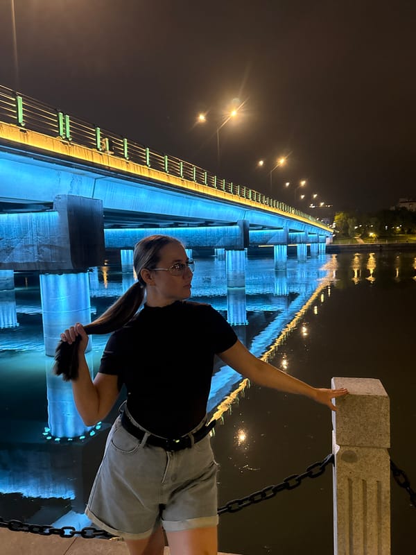 Night walk along Yiwu's illuminated riverfront bridges and promenade