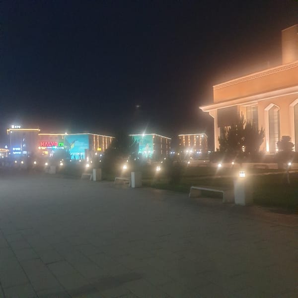 Nighttime stroll documented through illuminated Turkistan, Kazakhstan city center