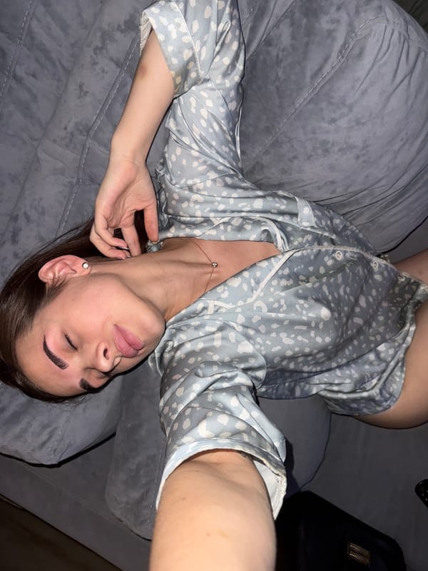 Woman rests on couch watching medical TV in Лобаново