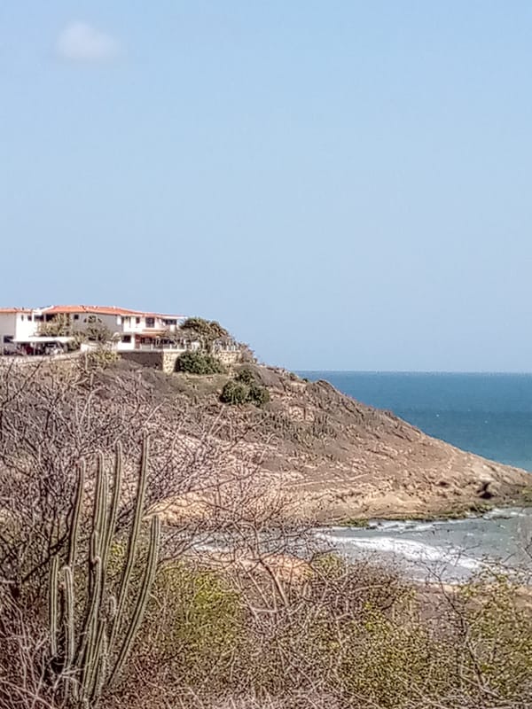 Orange-roofed house observed on rocky coastline in Juan Griego