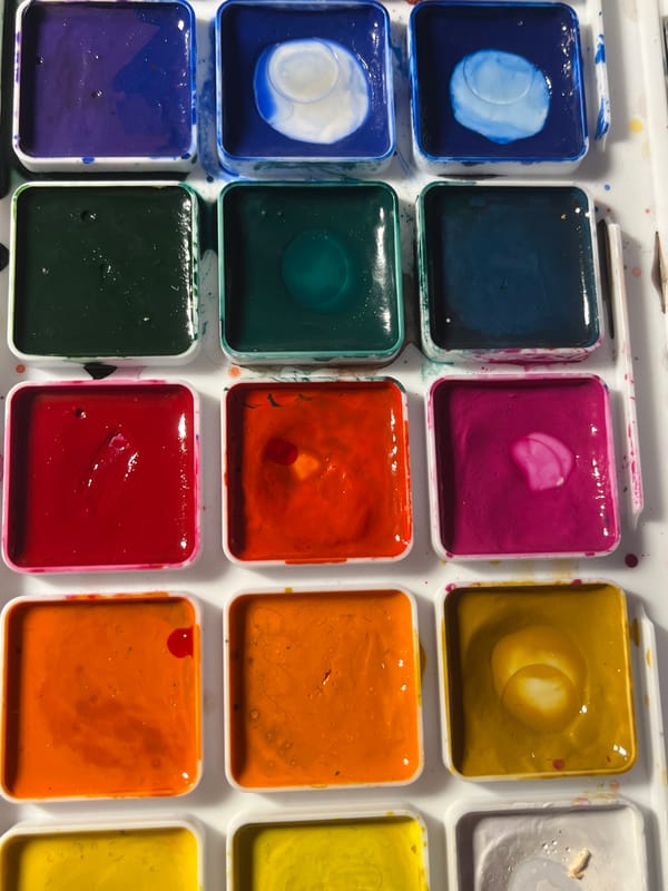 Artist documents watercolor painting session in Saint Petersburg workspace