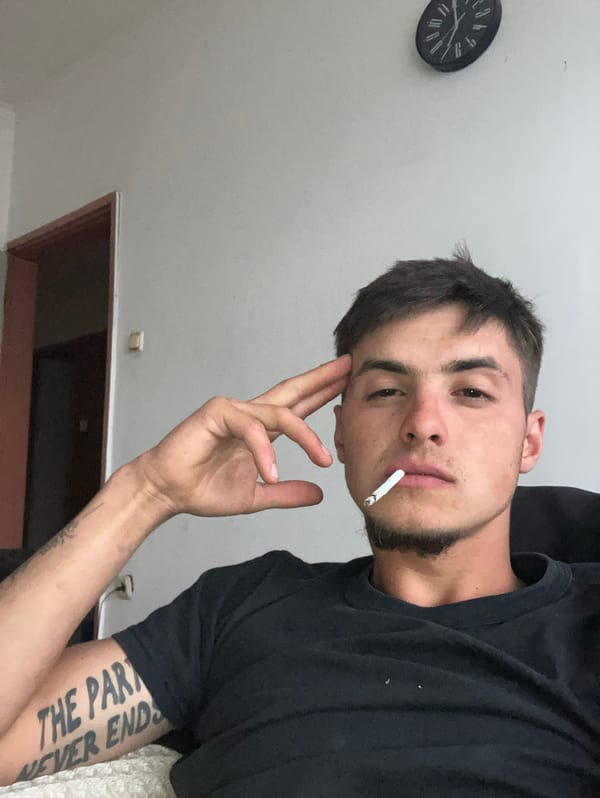 Young man photographs himself smoking, posing in Plovdiv bathroom